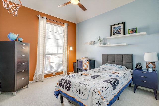 carpeted bedroom with ceiling fan with notable chandelier, baseboards, and lofted ceiling