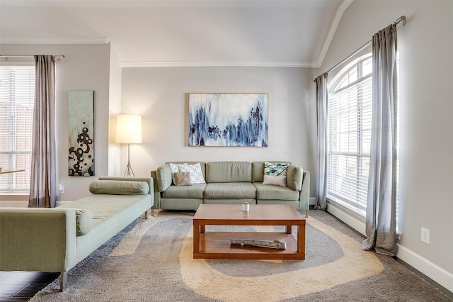 carpeted living room featuring baseboards and ornamental molding