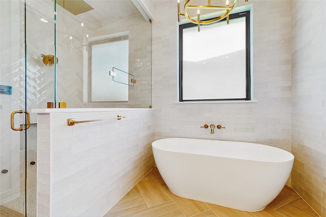 2031 Meadowlark Ct, Aledo, TX 76008 - full bath with a stall shower, a freestanding tub, a chandelier, and tile walls