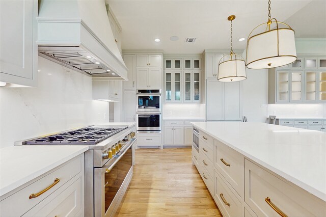 2031 Meadowlark Ct, Aledo, TX 76008 - kitchen featuring stainless steel appliances, custom range hood, light wood-style floors, white cabinetry, and recessed lighting