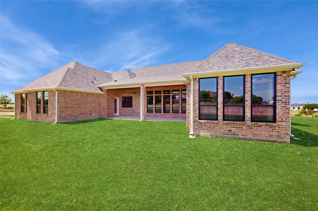 2031 Meadowlark Ct, Aledo, TX 76008 - rear view of house featuring roof with shingles, a lawn, brick siding, and a patio area