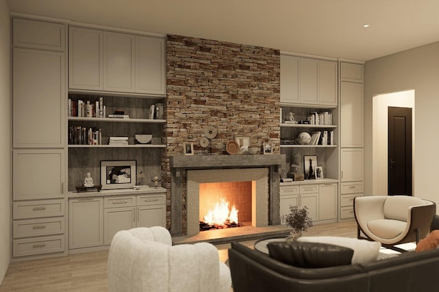 living area with a fireplace and light wood-style floors