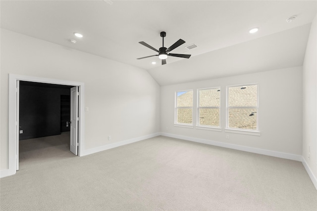 empty room with recessed lighting, lofted ceiling, light carpet, and ceiling fan