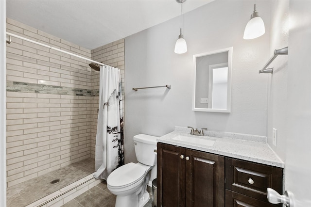 bathroom with tile patterned flooring, toilet, a stall shower, and vanity