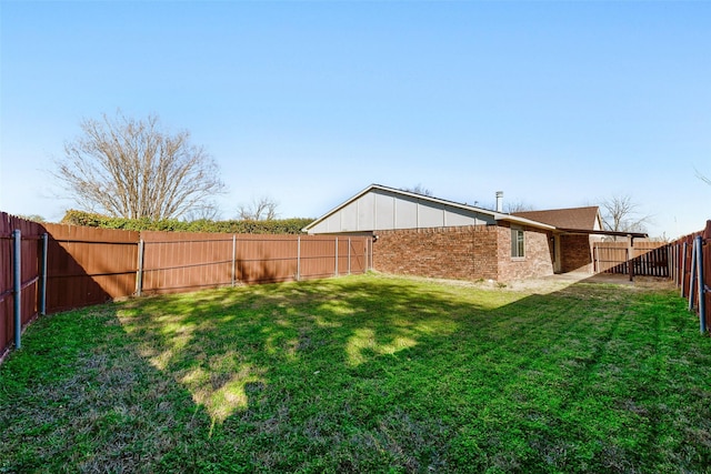 view of yard with a fenced backyard