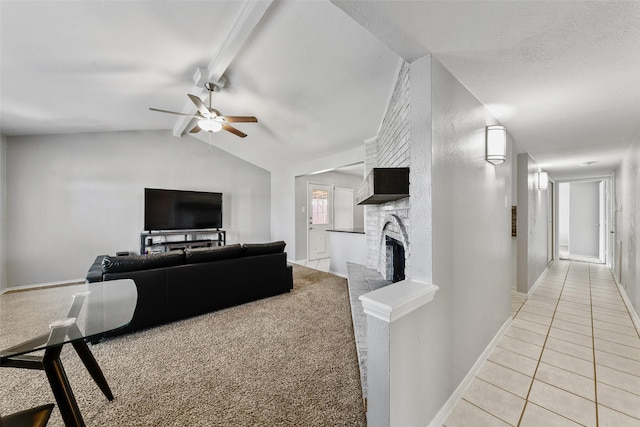 living area featuring lofted ceiling with beams, light tile patterned floors, baseboards, a brick fireplace, and ceiling fan