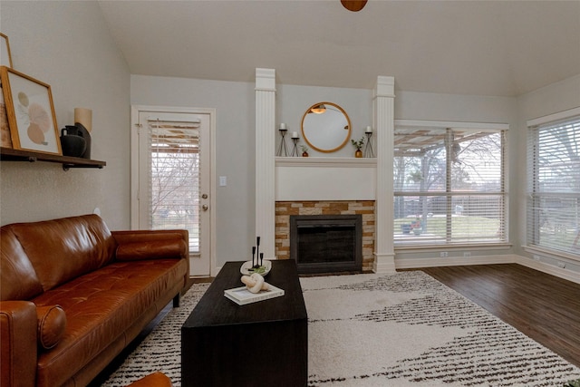 living room featuring baseboards, wood finished floors, and a fireplace