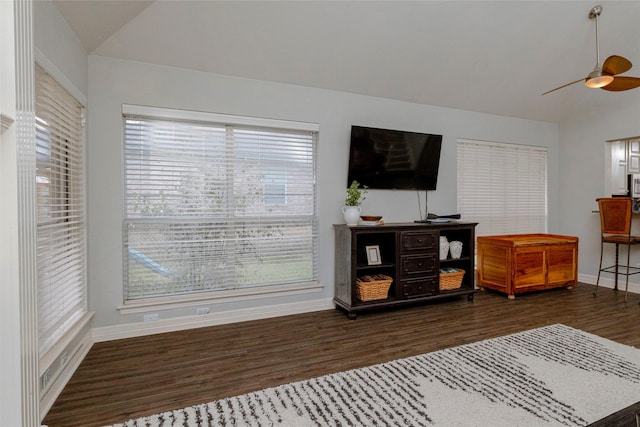 living room with ceiling fan, baseboards, wood finished floors, and vaulted ceiling