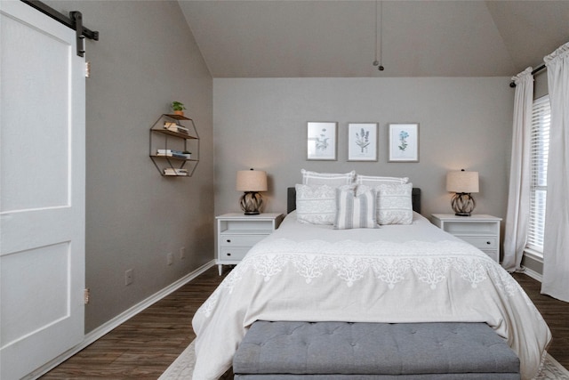 bedroom featuring a barn door, baseboards, dark wood-type flooring, and vaulted ceiling