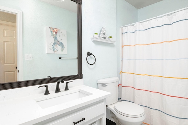 bathroom with vanity, curtained shower, and toilet