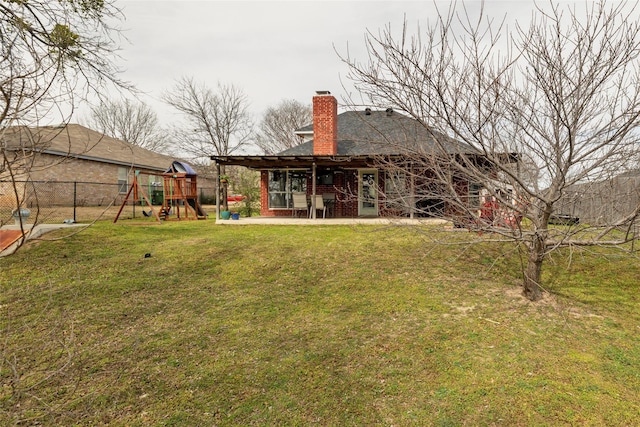 view of yard featuring a playground, a patio area, and fence