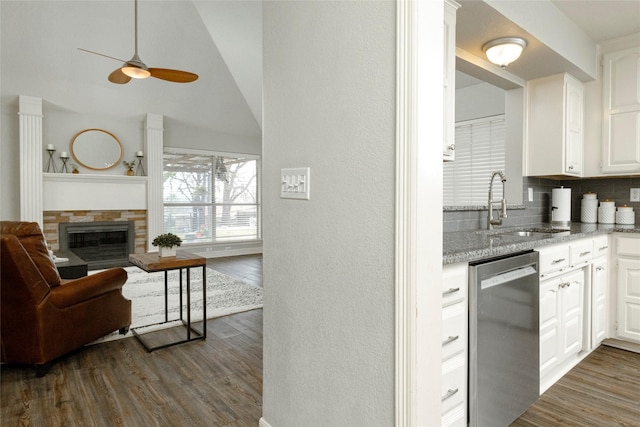 kitchen featuring dark wood-style floors, ceiling fan, a sink, white cabinets, and stainless steel dishwasher