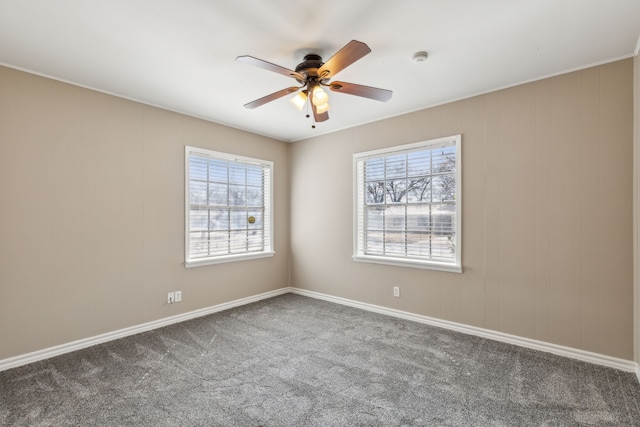 carpeted spare room featuring a ceiling fan