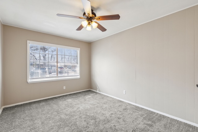 spare room featuring carpet and ceiling fan