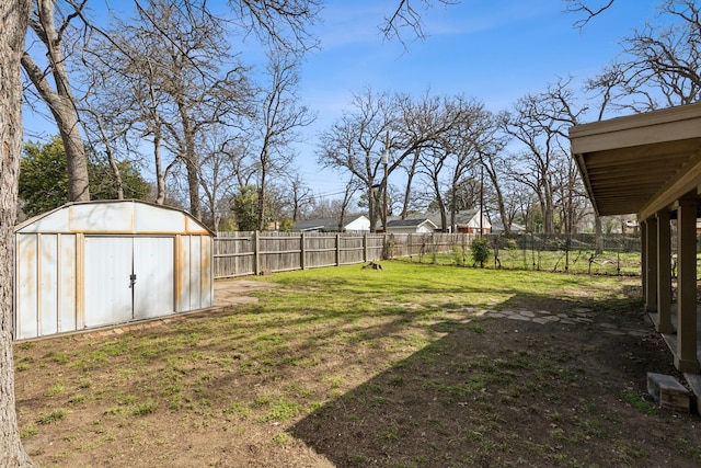 view of yard with an outbuilding, a shed, and a fenced backyard