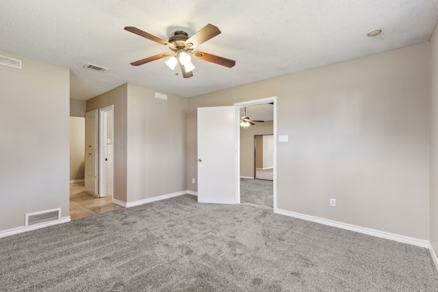 unfurnished bedroom with carpet flooring, baseboards, and visible vents