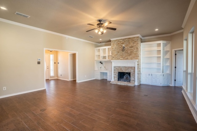 unfurnished living room with visible vents, dark wood-style floors, a stone fireplace, baseboards, and ceiling fan