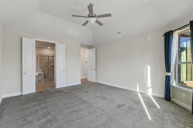 unfurnished bedroom featuring visible vents, carpet floors, baseboards, and vaulted ceiling