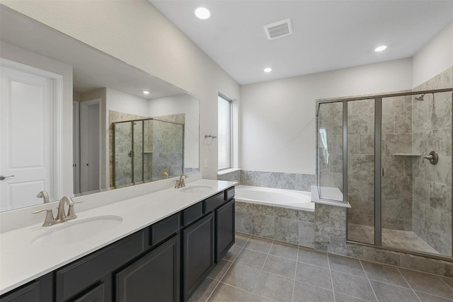 bathroom featuring visible vents, a stall shower, a sink, tile patterned flooring, and a garden tub