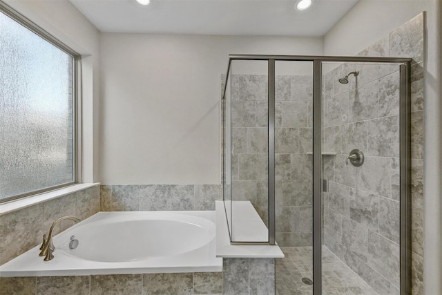 full bathroom featuring recessed lighting, a garden tub, and a stall shower