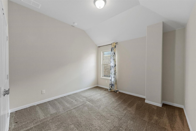 unfurnished room with vaulted ceiling, baseboards, and carpet floors