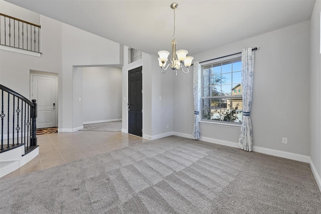 empty room featuring a notable chandelier, carpet, tile patterned flooring, baseboards, and stairs