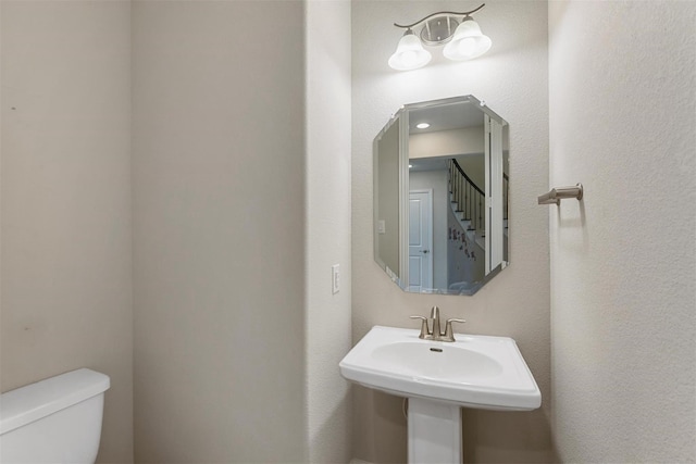 bathroom with toilet and a sink