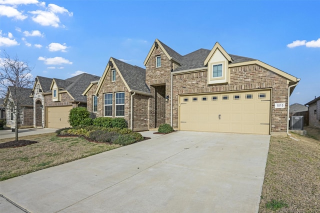 view of front of property featuring roof with shingles, concrete driveway, a garage, brick siding, and central AC unit