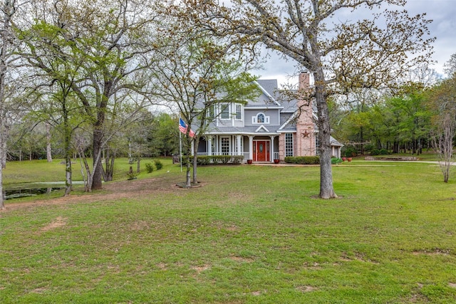 view of front of property featuring a front yard and a chimney