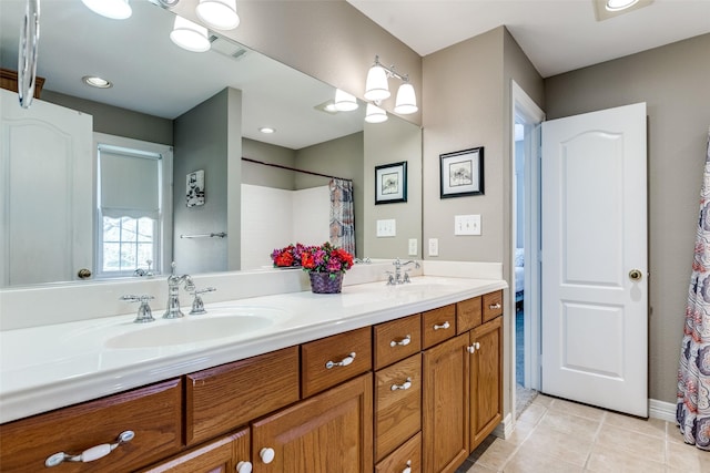 full bathroom featuring a sink, visible vents, double vanity, and tile patterned floors