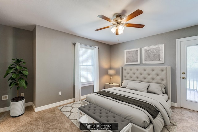 bedroom with multiple windows, baseboards, and light carpet