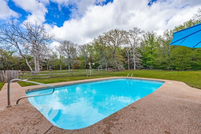 view of swimming pool featuring a fenced in pool, a patio, a lawn, and fence