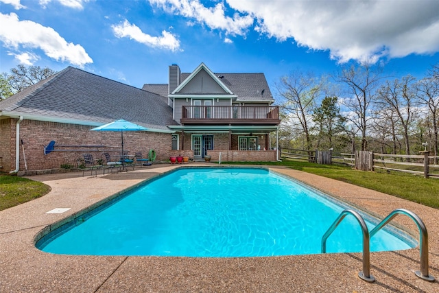 view of swimming pool featuring a patio area, a fenced in pool, a deck, and fence