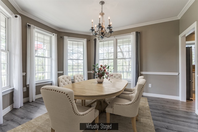 dining area featuring ornamental molding, baseboards, an inviting chandelier, and wood finished floors