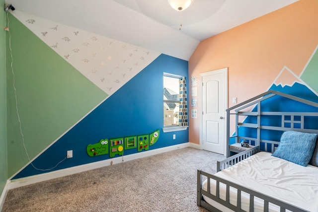 carpeted bedroom with vaulted ceiling and baseboards