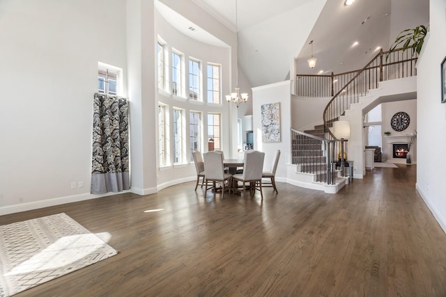 dining room with stairs, wood finished floors, and baseboards