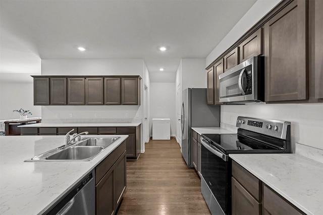 kitchen featuring a sink, dark brown cabinetry, recessed lighting, stainless steel appliances, and dark wood-style flooring