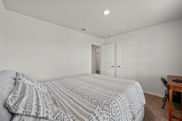 bedroom featuring carpet, visible vents, a closet, and baseboards