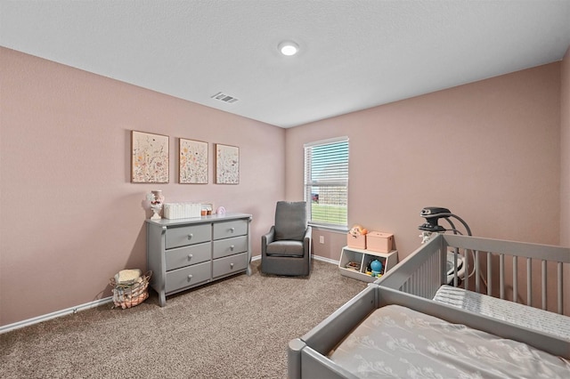 carpeted bedroom with a nursery area, visible vents, and baseboards