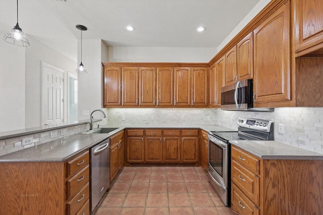 kitchen featuring a sink, stainless steel appliances, and brown cabinetry