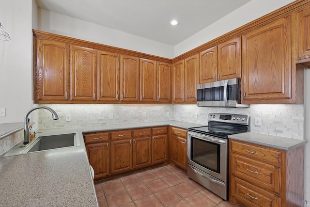 kitchen with a sink, brown cabinets, and appliances with stainless steel finishes