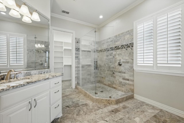 full bathroom featuring vanity, baseboards, visible vents, a stall shower, and crown molding