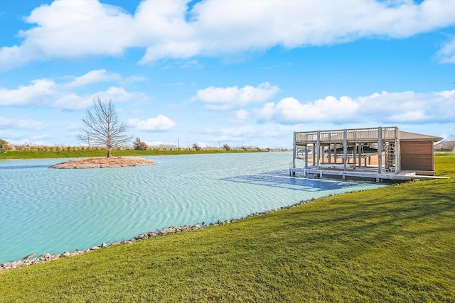 dock area with a yard and a water view