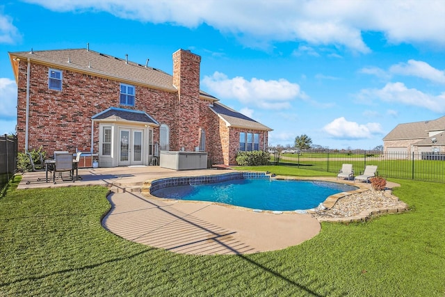 view of pool with a patio area, a lawn, french doors, and a fenced backyard