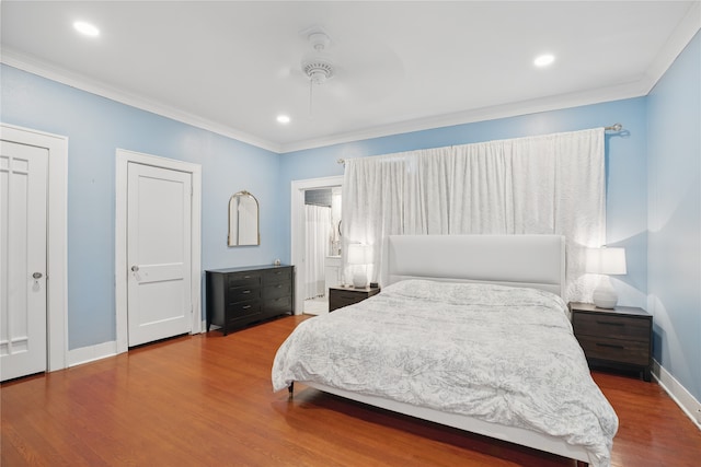 bedroom with recessed lighting, baseboards, wood finished floors, and ornamental molding