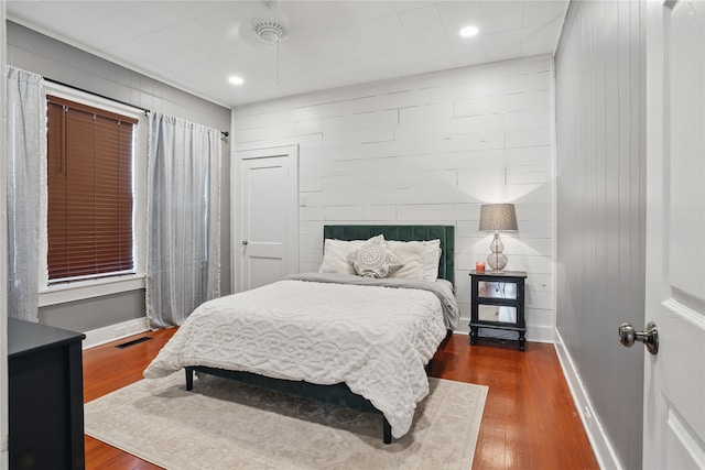 bedroom featuring visible vents, dark wood-type flooring, and baseboards