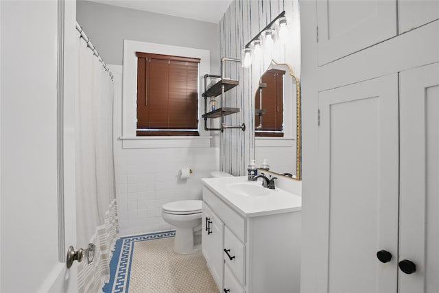 bathroom featuring tile walls, toilet, a shower with curtain, tile patterned floors, and vanity