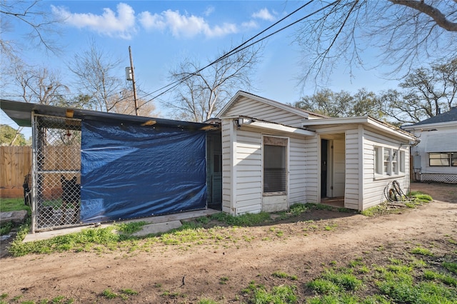 exterior space with an outbuilding and fence