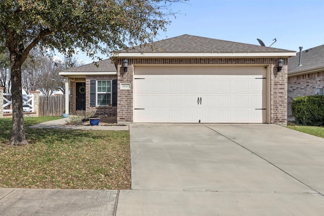 view of front facade featuring concrete driveway, fence, brick siding, and roof with shingles