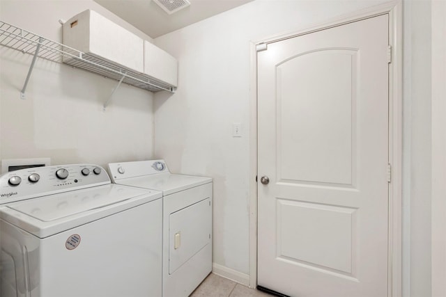 laundry room with light tile patterned floors, baseboards, visible vents, laundry area, and washer and clothes dryer